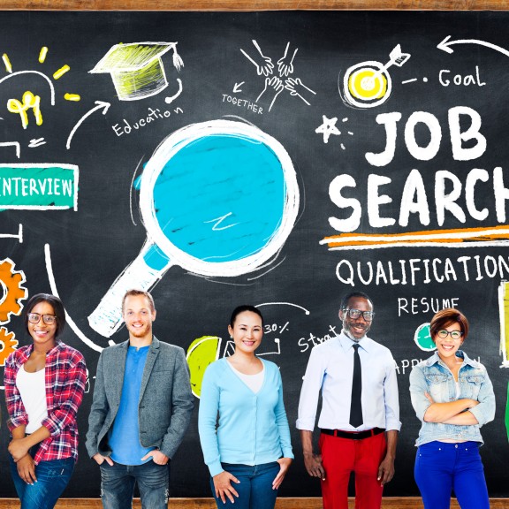 Diverse job applicants in front of chalkboard