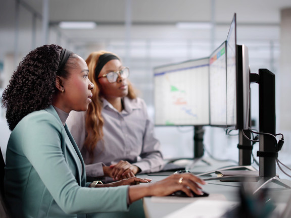 Internship, intern working and supervisor looking on