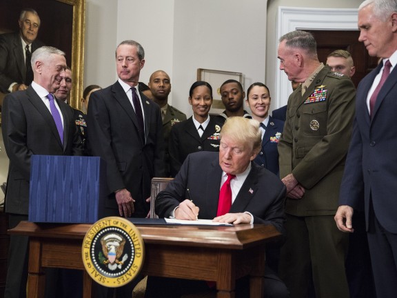 U.S. President Donald Trump signs the National Defense Authorization Act (NDAA) for fiscal year 2018 in the Roosevelt Room of the White House in Washington, D.C., U.S. on Tuesday, Dec. 12, 2017. Photographer: Joshua Roberts/Bloomberg