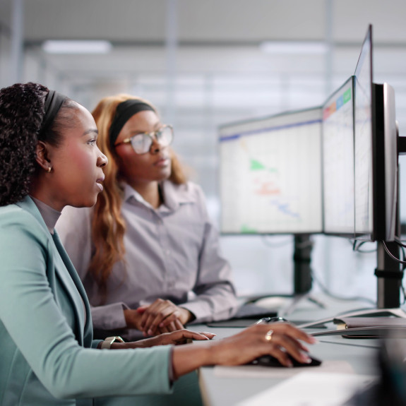 Internship, intern working and supervisor looking on